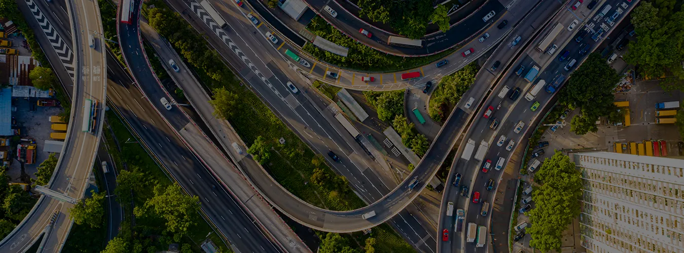 Aerial view of a complex highway interchange with multiple lanes, overpasses, and vehicles