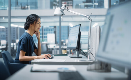 Professional developer working at modern office desk with computer, representing application security testing and development workflow