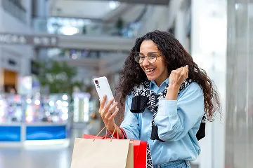 Traveler Checking Phone at Airport