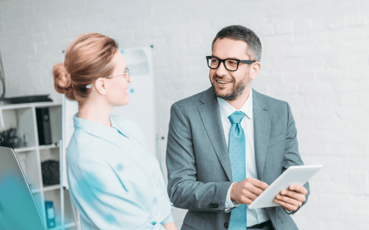 Two business professionals collaborating in modern office - HCL Unica v12.1.9 release